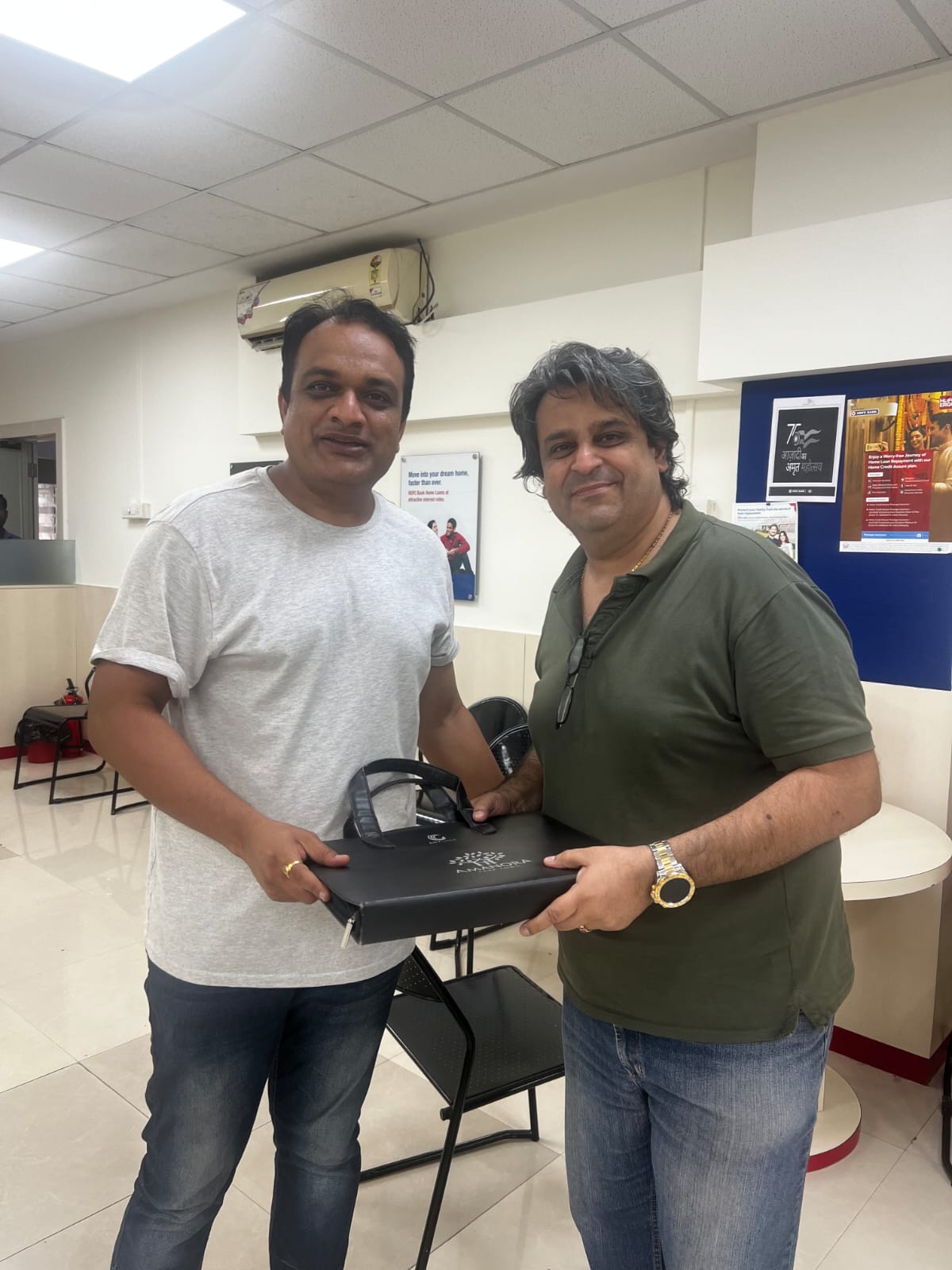 A happy customer receiving their handover gift